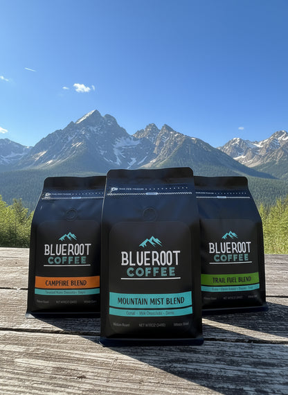 Three Blueroot Coffee bags with mountain scenery in the background