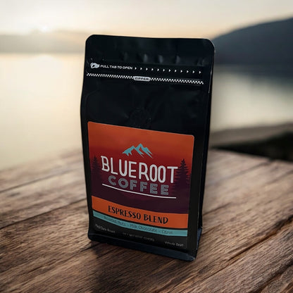 Black coffee bag with 'Blueroot Coffee' label on a wooden surface